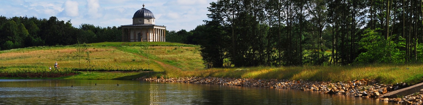 Lake with domed structure and tress in the background