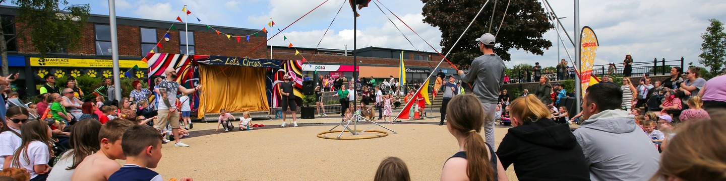 Image of people watching an outdoor performance in Spennymoor