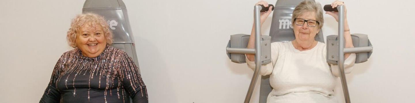 two people using gym equipment